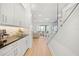 Bright kitchen with white cabinets, granite countertops, and views of the living room and lake at 16689 Broadwater Ave, Winter Garden, FL 34787