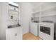Functional laundry room with a sink, washer, dryer, and ample shelving for storage at 16689 Broadwater Ave, Winter Garden, FL 34787