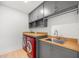 Well-organized laundry room with modern appliances, ample counter space, and storage cabinets for convenience at 16689 Broadwater Ave, Winter Garden, FL 34787