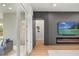 Elegant living room featuring a modern fireplace and mounted TV, leading to an outdoor seating area at 16689 Broadwater Ave, Winter Garden, FL 34787