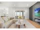 Bright living room with a lake view, fireplace, wood floors, and access to a patio at 16689 Broadwater Ave, Winter Garden, FL 34787