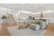 Open concept living room with a modern kitchen, stairwell, and living area with natural light at 16689 Broadwater Ave, Winter Garden, FL 34787