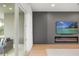Elegant living room featuring a modern fireplace and mounted TV, leading to an outdoor seating area at 16689 Broadwater Ave, Winter Garden, FL 34787