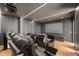 Home theater with comfortable seating, a large screen, and modern lighting at 16689 Broadwater Ave, Winter Garden, FL 34787