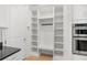Bright mudroom features built-in shelving, a bench, and hanging hooks for storage and organization at 16689 Broadwater Ave, Winter Garden, FL 34787