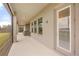 Long covered patio with access to the outdoors through multiple windows and doors; stylish and relaxing space at 16689 Broadwater Ave, Winter Garden, FL 34787