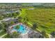 Birds eye view of a community pool with palm trees, lounge chairs, covered seating and a view of green space and walking paths at 16689 Broadwater Ave, Winter Garden, FL 34787