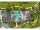 Aerial view of community pool with beach entry, palm trees, playground, picnic pavilion and winding sidewalks at 16689 Broadwater Ave, Winter Garden, FL 34787