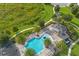 An aerial view features a community pool with shade pavilion, playground, and lush greenery at 16689 Broadwater Ave, Winter Garden, FL 34787