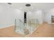 Modern staircase with glass railings and wood steps offers a bright and open transition between floors at 16689 Broadwater Ave, Winter Garden, FL 34787