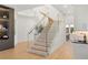 Modern staircase with glass railings and wood steps, leading to the upper level at 16689 Broadwater Ave, Winter Garden, FL 34787