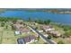 Aerial view of waterfront houses, showcasing a pool and lake proximity in a residential neighborhood at 16752 Caravaggio Loop, Montverde, FL 34756
