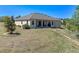 Back exterior shot showcasing a brick-paved walkway, and spacious lawn at 16752 Caravaggio Loop, Montverde, FL 34756