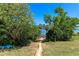 Scenic backyard view with a stone-paved walkway leading to the lake at 16752 Caravaggio Loop, Montverde, FL 34756