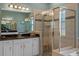 Bathroom features a large tile shower, decorative tile accent, and double sinks at 16752 Caravaggio Loop, Montverde, FL 34756