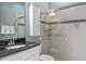 This bathroom features a vanity with granite countertops, and a glassed-in shower at 16752 Caravaggio Loop, Montverde, FL 34756