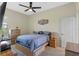 This bedroom features a ceiling fan and a large window at 16752 Caravaggio Loop, Montverde, FL 34756