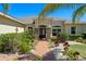 Stone accented entrance with brick walkway and lush landscaping at 16752 Caravaggio Loop, Montverde, FL 34756