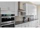 Modern kitchen with stainless steel appliances, white cabinets, and a stylish backsplash at 16752 Caravaggio Loop, Montverde, FL 34756