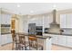 Modern kitchen with stainless steel appliances, granite countertops, and a breakfast bar with seating at 16752 Caravaggio Loop, Montverde, FL 34756