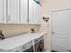 This laundry room has upper cabinets, counter space, and a washer-dryer at 16752 Caravaggio Loop, Montverde, FL 34756