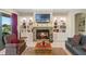 Cozy living room featuring a stone fireplace with built-in shelving and water views at 16752 Caravaggio Loop, Montverde, FL 34756