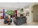 Bright living room with a stone fireplace, built-in bookshelves, and sliding glass doors to a water view at 16752 Caravaggio Loop, Montverde, FL 34756