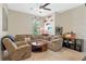 Cozy living room with comfortable seating, a ceiling fan, and natural light at 16752 Caravaggio Loop, Montverde, FL 34756