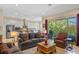 Open-concept living room featuring a view to the kitchen and access to an outdoor patio at 16752 Caravaggio Loop, Montverde, FL 34756