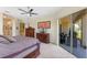 Spacious main bedroom includes a ceiling fan, closet, and sliding glass door at 16752 Caravaggio Loop, Montverde, FL 34756