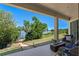 Covered patio featuring a lovely lake view, outdoor furniture, and a stylish stone fire pit at 16752 Caravaggio Loop, Montverde, FL 34756