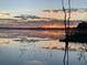 Stunning water view with vibrant sunrise over the calm lake waters at 16752 Caravaggio Loop, Montverde, FL 34756