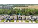 An aerial view of the neighborhood shows the homes, landscaping, and proximity to the pond and surrounding community at 17411 Million Lakes Ct, Clermont, FL 34714
