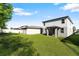 Large backyard with lush green grass surrounding the home, perfect for outdoor activities and relaxation at 17411 Million Lakes Ct, Clermont, FL 34714