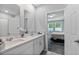The bright bathroom features double sinks, a modern design, and ample counter space at 17411 Million Lakes Ct, Clermont, FL 34714