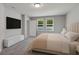 Bright bedroom features plush carpet, two windows, and neutral paint, creating a serene and inviting space at 17411 Million Lakes Ct, Clermont, FL 34714