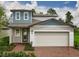 Charming two-story home featuring a two-car garage and landscaped front yard at 17411 Million Lakes Ct, Clermont, FL 34714