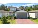 Charming two-story home featuring a red brick driveway, a two-car garage, and well-maintained landscaping at 17411 Million Lakes Ct, Clermont, FL 34714