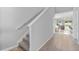 Hallway showcasing the transition between the lower and upper floors, featuring tile flooring and carpeted stairs at 17411 Million Lakes Ct, Clermont, FL 34714