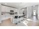 Modern kitchen featuring white cabinets, stainless steel appliances, and a spacious island with seating for four at 17411 Million Lakes Ct, Clermont, FL 34714