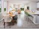 Bright and open-concept living space with a dining area, bar seating, and large windows with natural light at 17411 Million Lakes Ct, Clermont, FL 34714