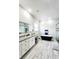 Bright bathroom with dual sinks, granite counters, soaking tub, and a tiled shower with glass doors at 18721 Seaview St, Orlando, FL 32833