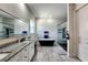 Bright bathroom with dual sinks, granite counters, soaking tub, and a tiled shower with glass doors at 18721 Seaview St, Orlando, FL 32833