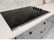 A close-up of the modern cooktop, highlighting its sleek design and functionality, set against elegant countertops at 18721 Seaview St, Orlando, FL 32833