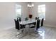 Bright dining area with a modern table, black and white chairs, and a view through the windows, creating a welcoming space at 18721 Seaview St, Orlando, FL 32833