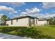 Side exterior showcasing the landscaping and neutral colors at 18721 Seaview St, Orlando, FL 32833