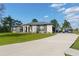 Beautiful home exterior featuring manicured lawn, stone accents, and a long driveway at 18721 Seaview St, Orlando, FL 32833