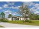 Single-story home exterior with neutral colors, manicured lawn, and mature tree at 18721 Seaview St, Orlando, FL 32833