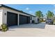 Spacious three-car garage with black doors and a wide driveway, offering ample parking at 18721 Seaview St, Orlando, FL 32833