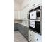 This modern kitchen features stainless steel appliances, a built-in wine rack, and stylish tile floors, combining function and style at 18721 Seaview St, Orlando, FL 32833